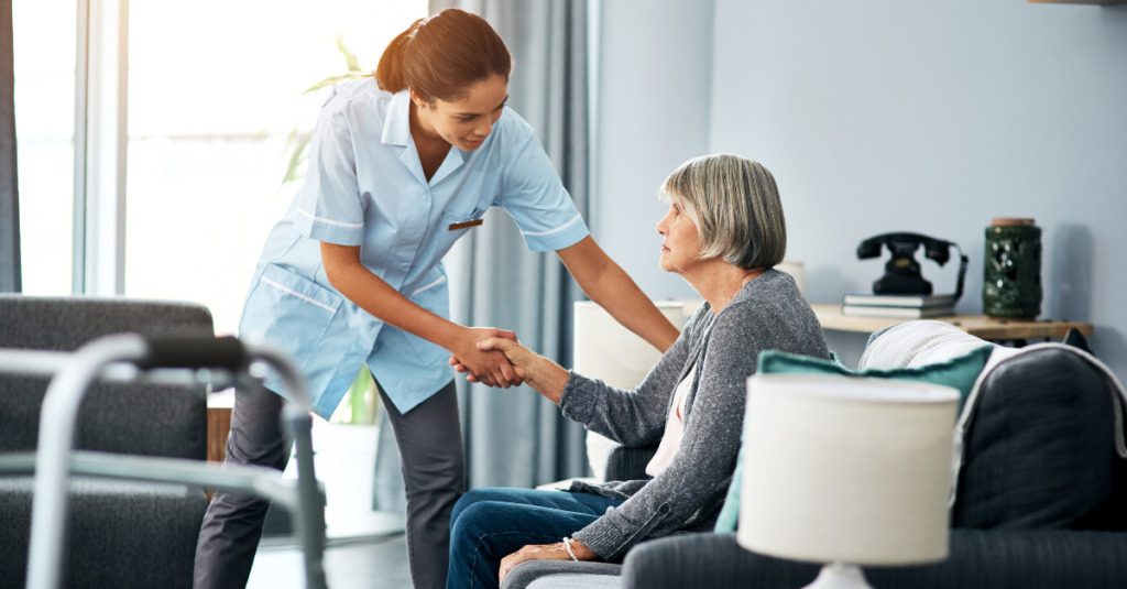 Healthcare worker with patient in long-term care facility
