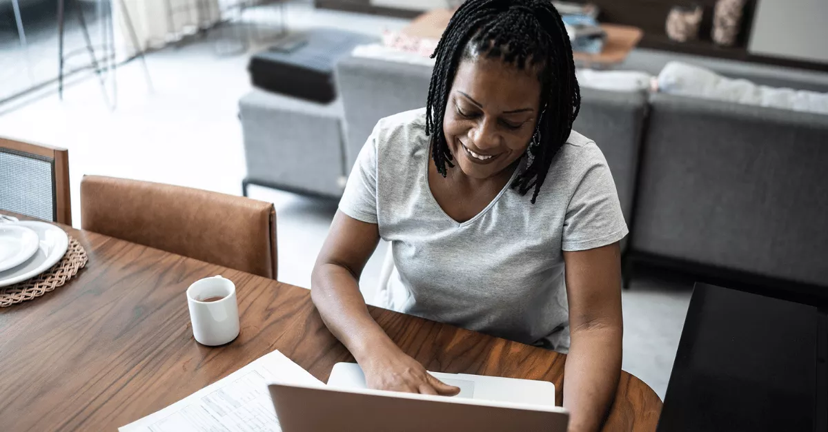 A woman working remotely from her kitchen table