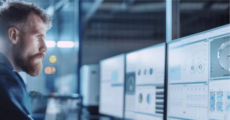 Person sitting at computer screens incident response plan
