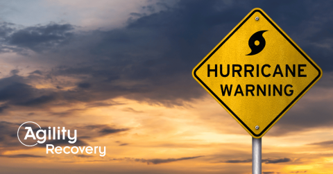hurricane warning sign over a darkening sky