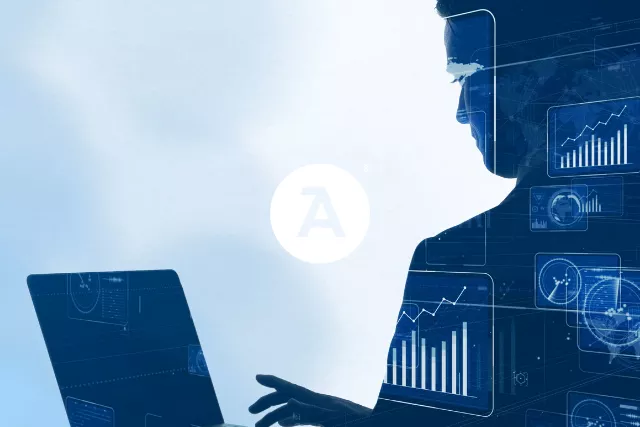 silhouette of a person working at a computer representing Cybersecurity