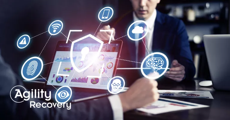Cybersecurity icons over a person working