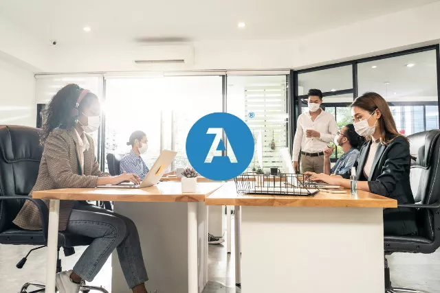people working at desks with masks