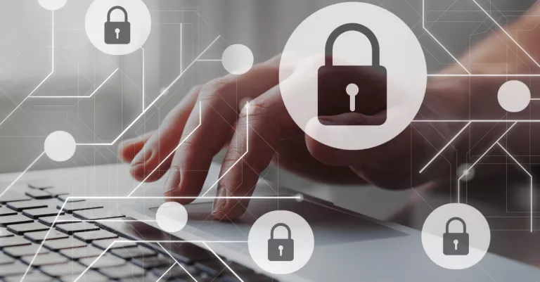 hand on a keyboard with padlock icons representing cybersecurity