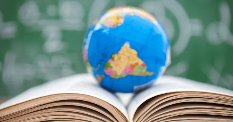 A globe sitting on top of an open book