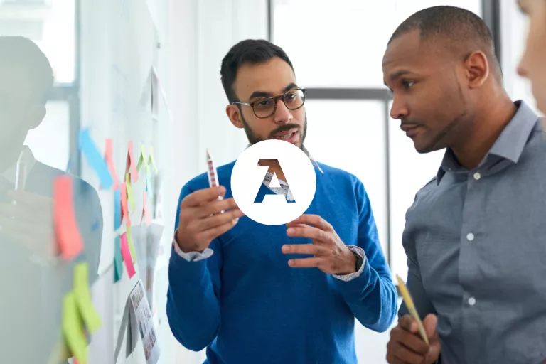 Two people working at a whiteboard