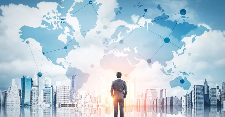 Person standing in front of buildings and a map