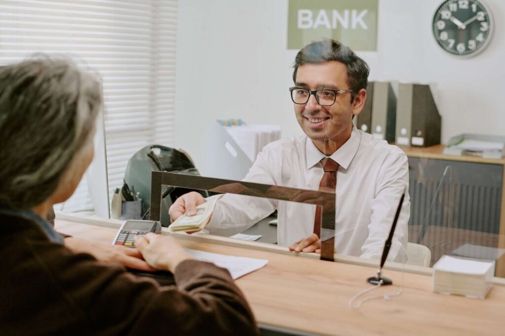 An employee works with a credit union member