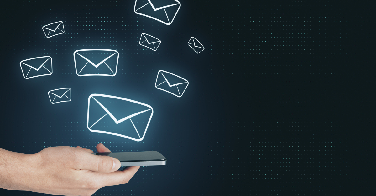 a person holding a cell phone with email icons floating above it