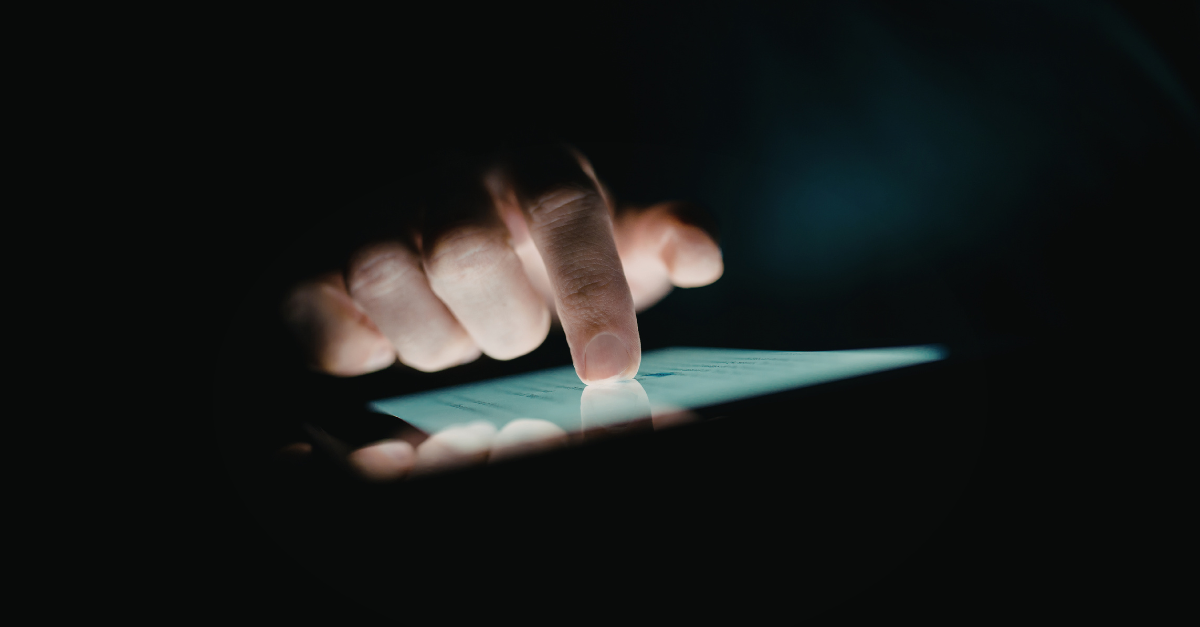 A person looks at their phone in the middle of the night